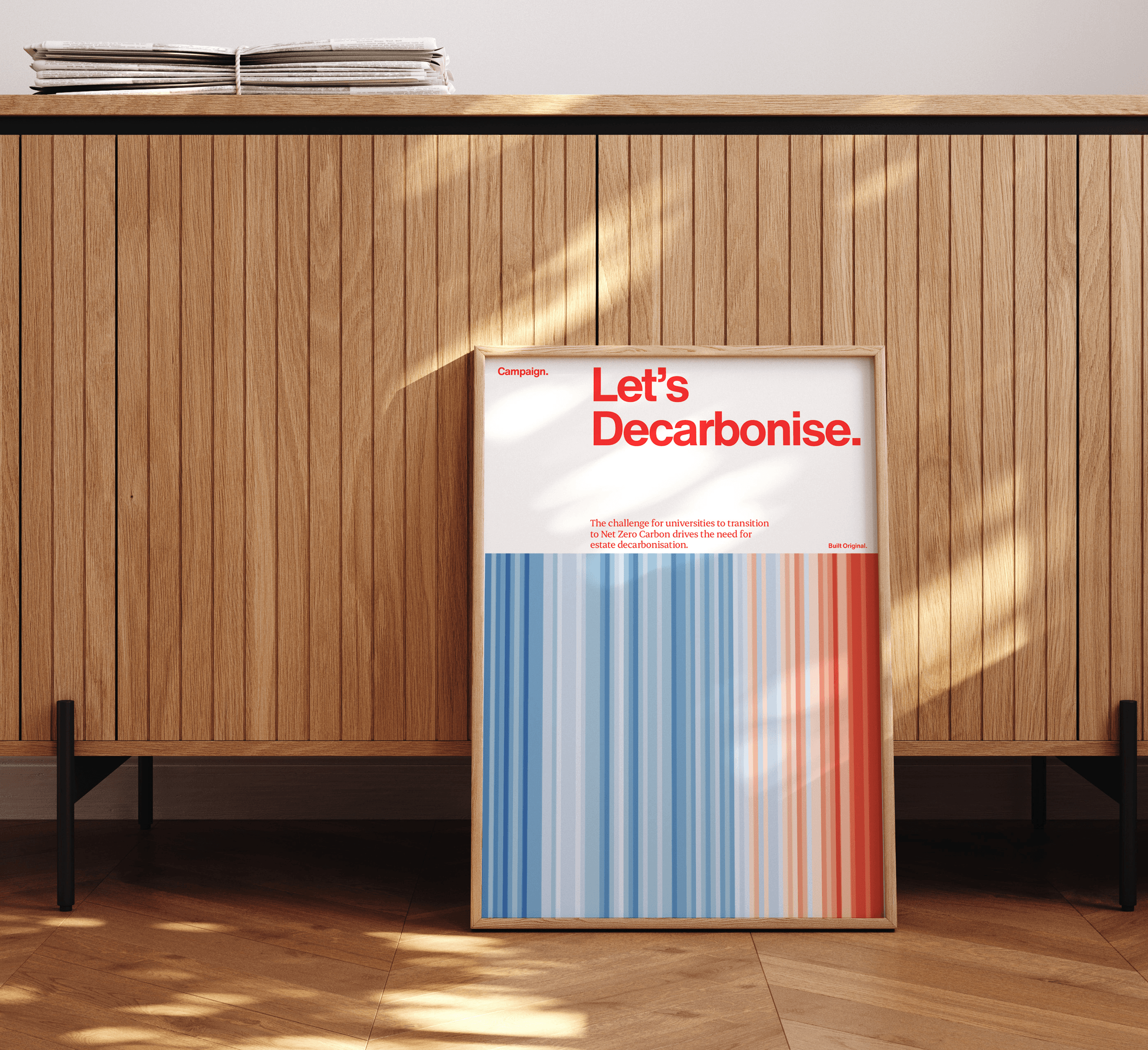BDP Poster in wooden frame in office against sideboard